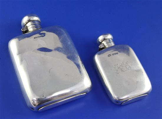 Two silver hip flasks.